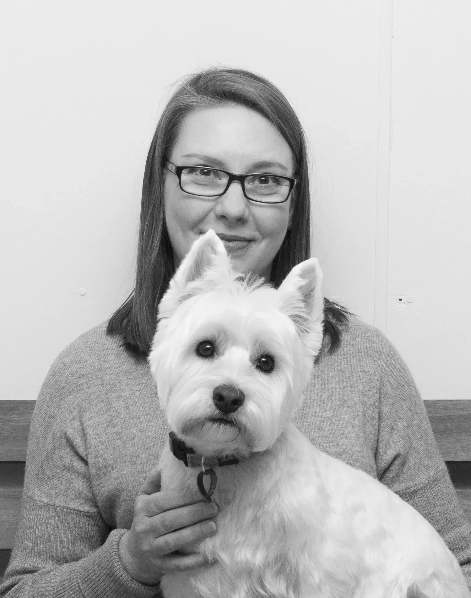 Susie Rosetzky, owner and head groomer at Dogs of the North, holding Gracie the resident Westie